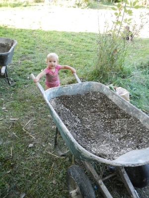Kaia helping with the cob oven
