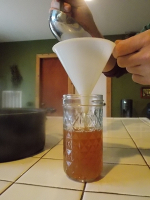 pouring the medicine into a jar