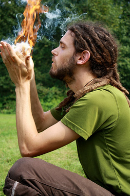 blowing a  coal into a flame