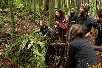 group constructing a debris hut